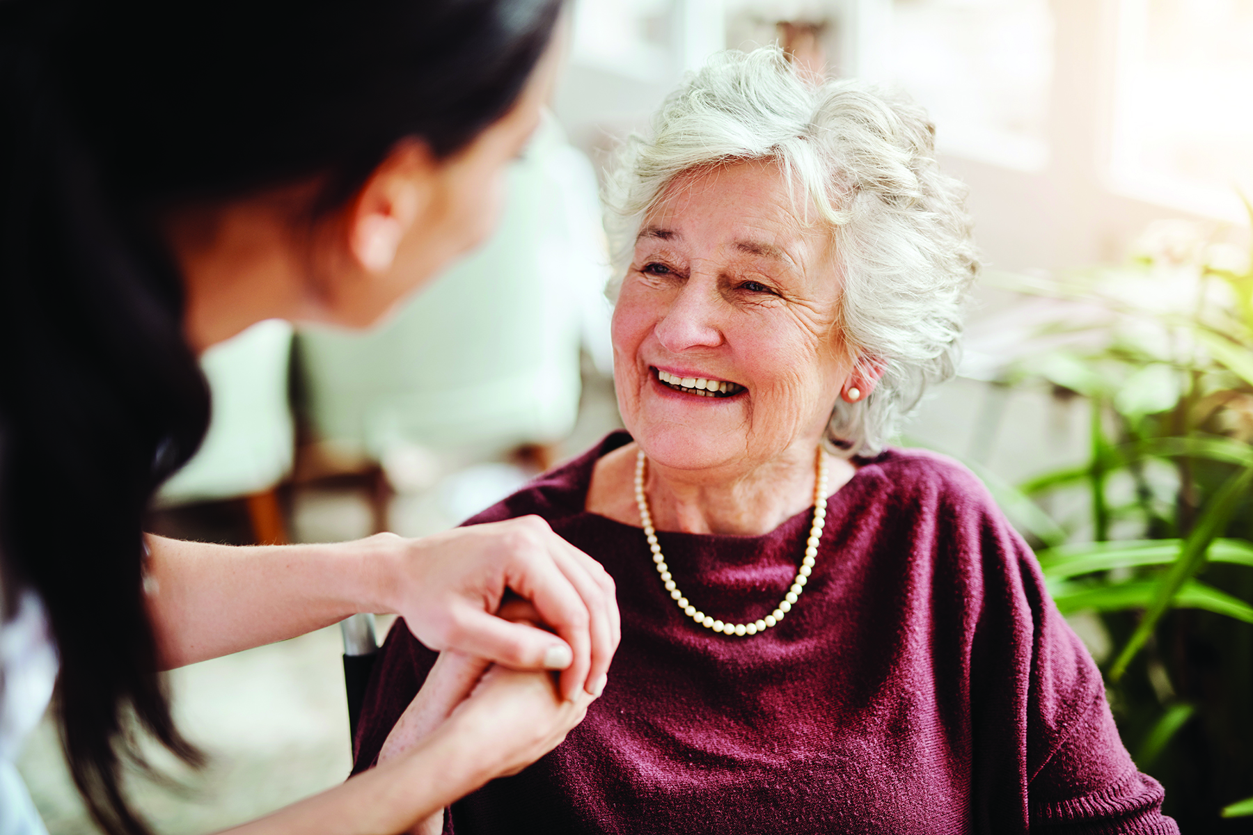 Caregiver supporting a resident in a senior living community