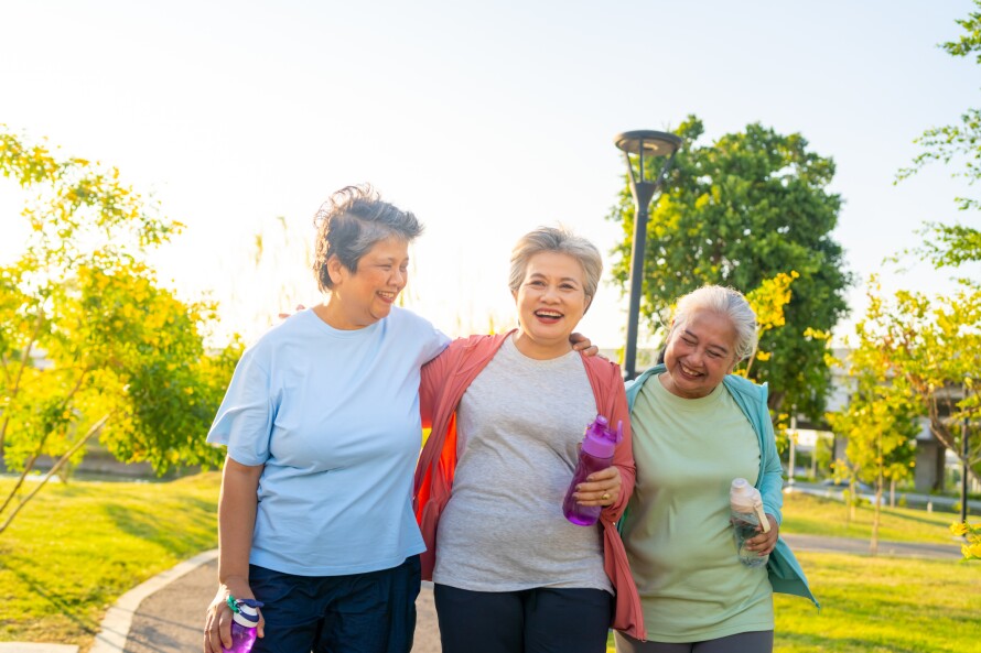 Group of Cheerful active senior women exercising together at park